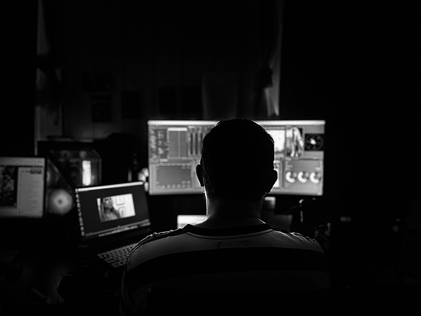 Person editing digital content at a workstation